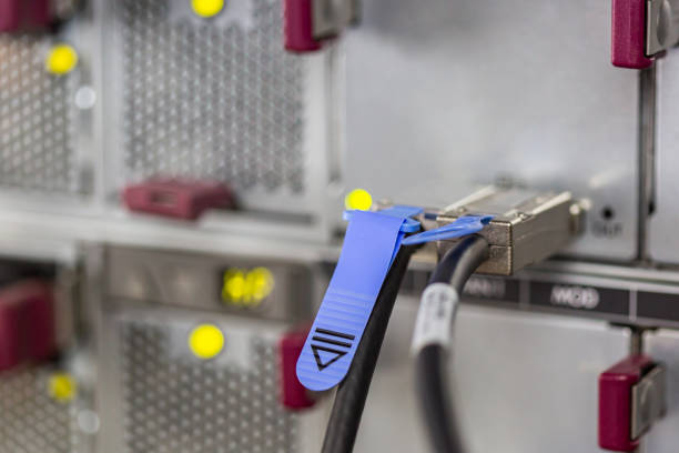 Close-up of data cable plug connected to servers in computer lab storage sas