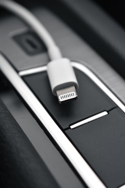 A detailed close-up image of a lightning connector against a sleek black surface, ideal for tech themes.
