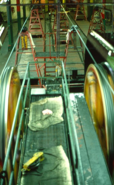 Close-up view of an industrial conveyor belt in a factory setting.