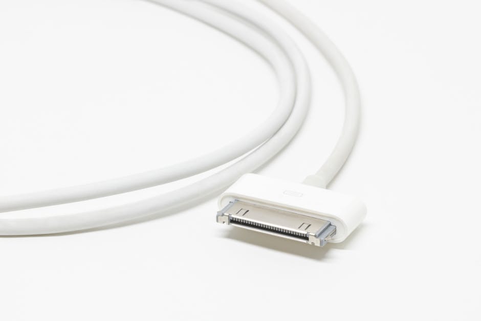 Close-up of a white USB charging cable on a white background.