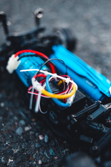 Macro shot of vibrant colored wires and components of an RC car model, showcasing detailed electronics.