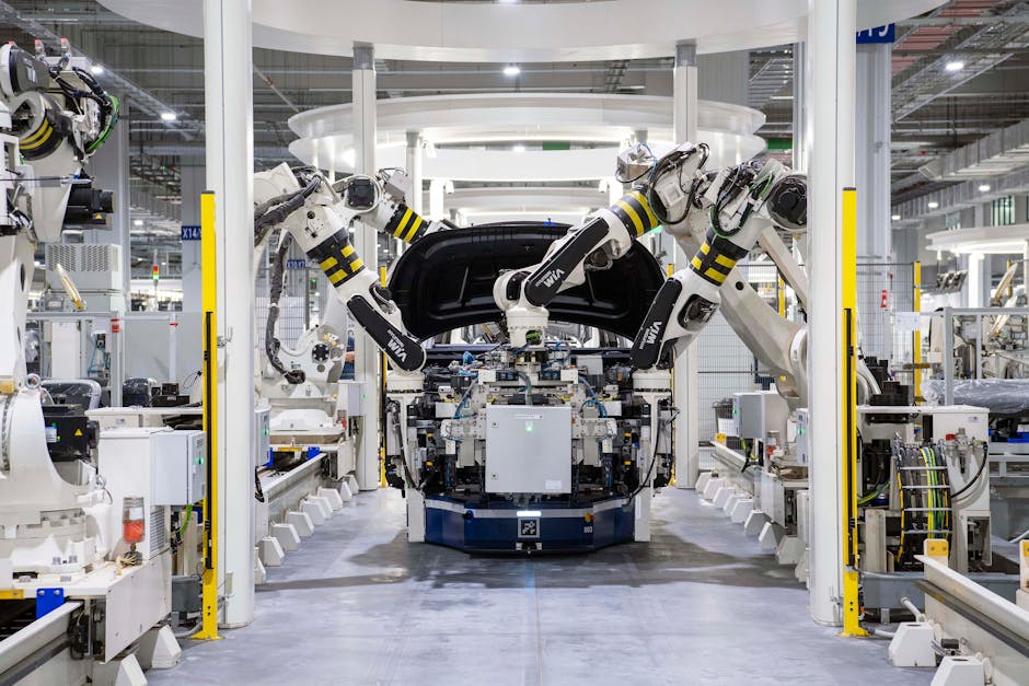 High-tech robots assembling a car in a modern factory setting, showcasing automation. High-tech robots assembling a car in a modern factory setting, showcasing automation.