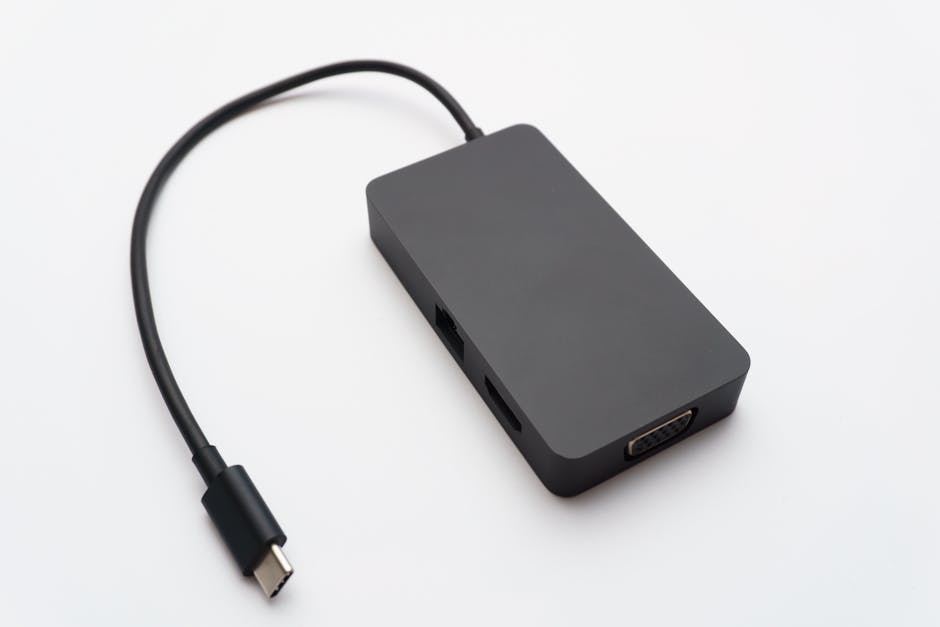 Sleek USB-C hub with HDMI, USB, and Ethernet ports on white background.