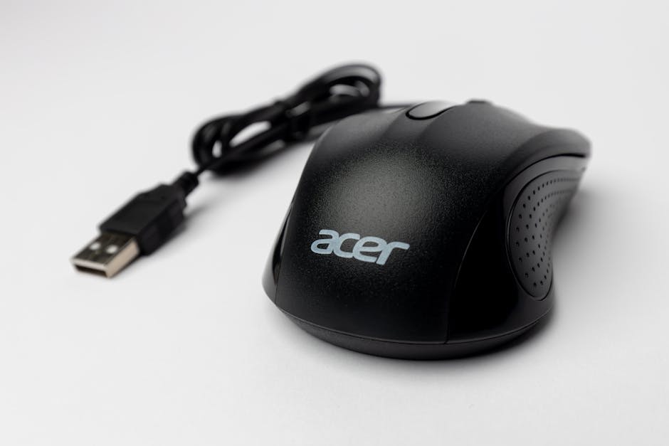 Close-up of a black computer mouse with USB cable on a white background.