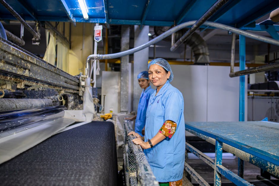 Women in a textile factory, working on machinery, showcasing teamwork and industry. Women in a textile factory, working on machinery, showcasing teamwork and industry.