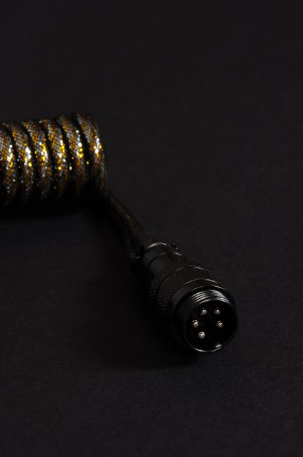 A close-up shot of a coiled cable with a black connector, ideal for technology or design concepts.