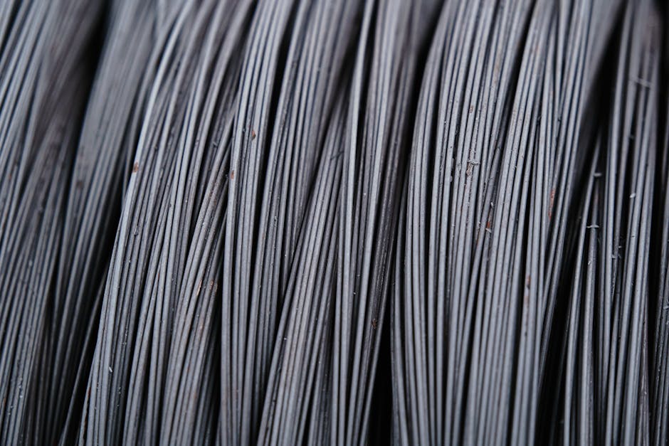 Detailed macro shot of intertwined metal wires, showcasing industrial texture.