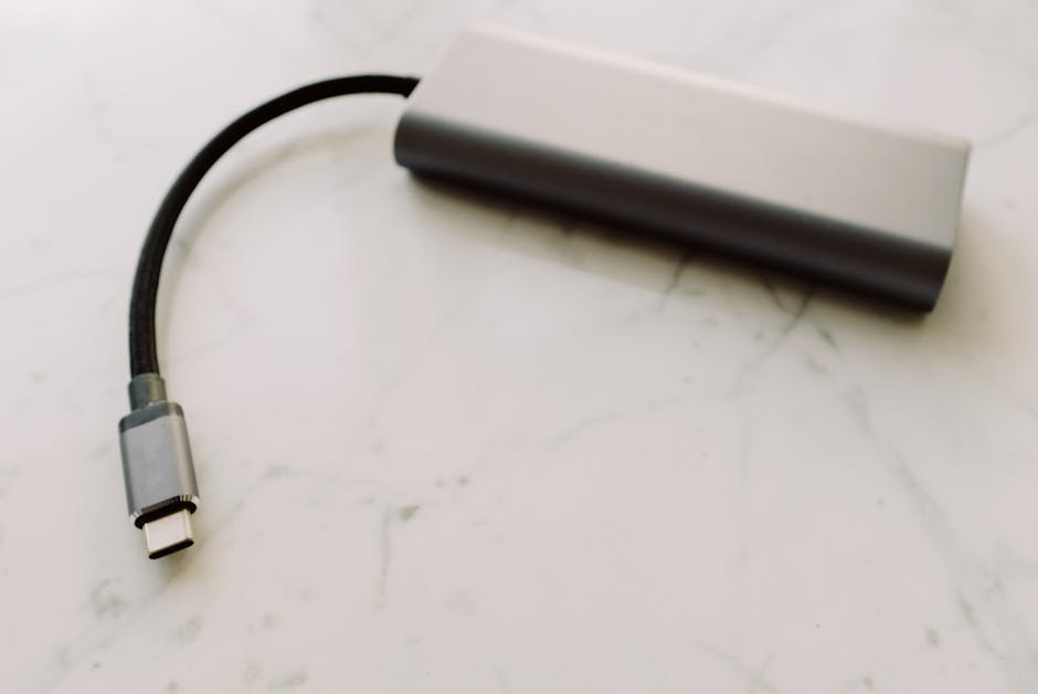 Крупный план USB-C адаптера на мраморной поверхности, демонстрирующего современные технологии.