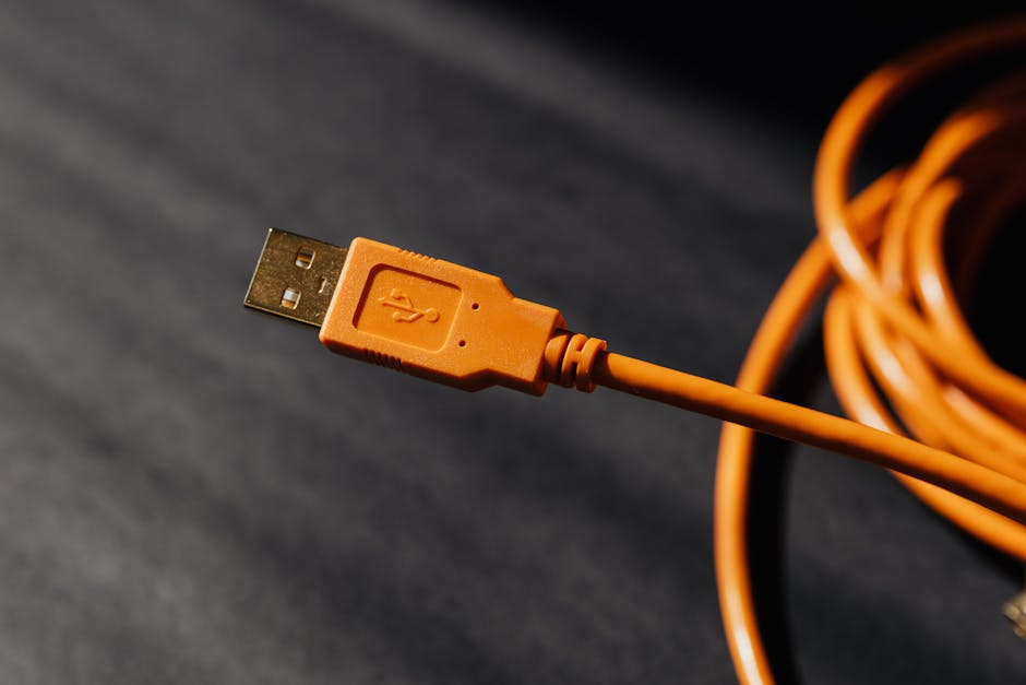 Detailed macro photo of an orange USB cable connector with focus on texture.