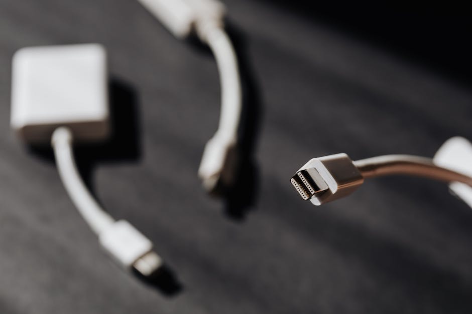 Macro photo showcasing close-up of USB cables and connectors on dark surface.