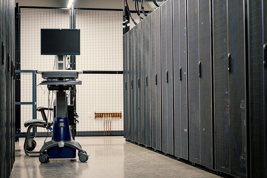 Contemporary computer on support between telecommunication racks and cabinets in modern data center Contemporary computer on support between telecommunication racks and cabinets in modern data center