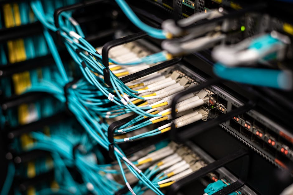 Close-up of network server showing organized cable management and patch panels in a data center. Close-up of network server showing organized cable management and patch panels in a data center.