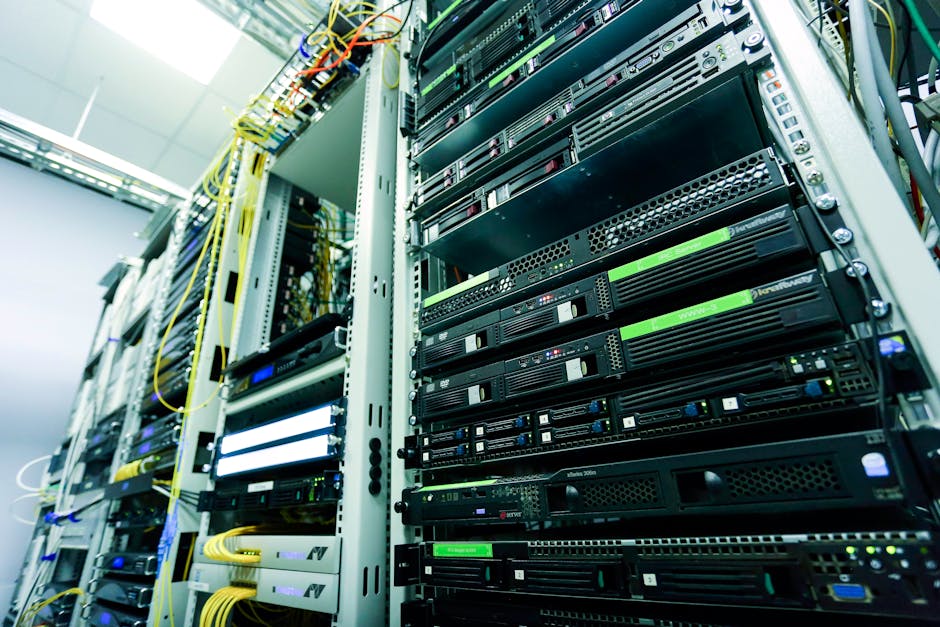 High-tech server rack in a secure data center with network cables and hardware components. High-tech server rack in a secure data center with network cables and hardware components.