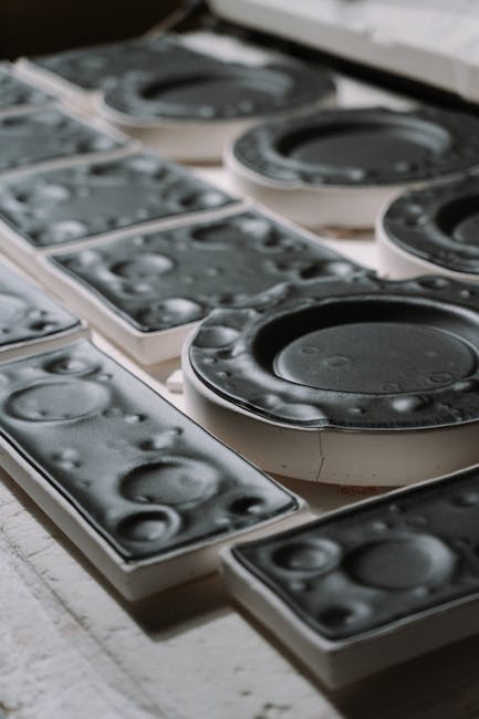 Detailed image of black plastic injection molds used in manufacturing industry.