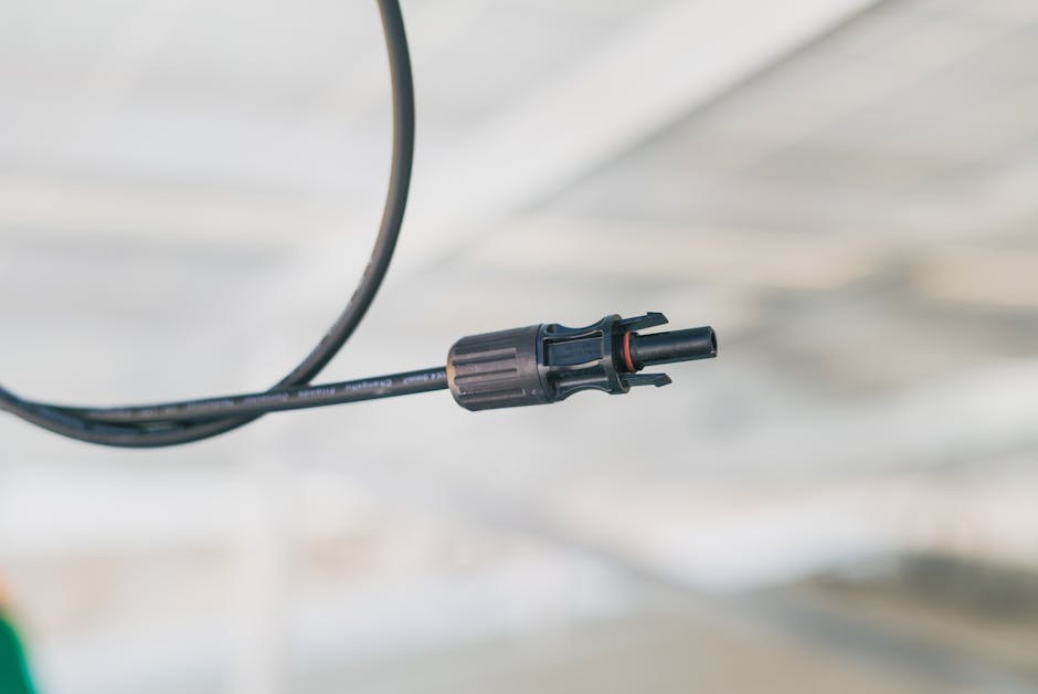 Detailed close-up shot of an electrical connector cable with a blurred background.