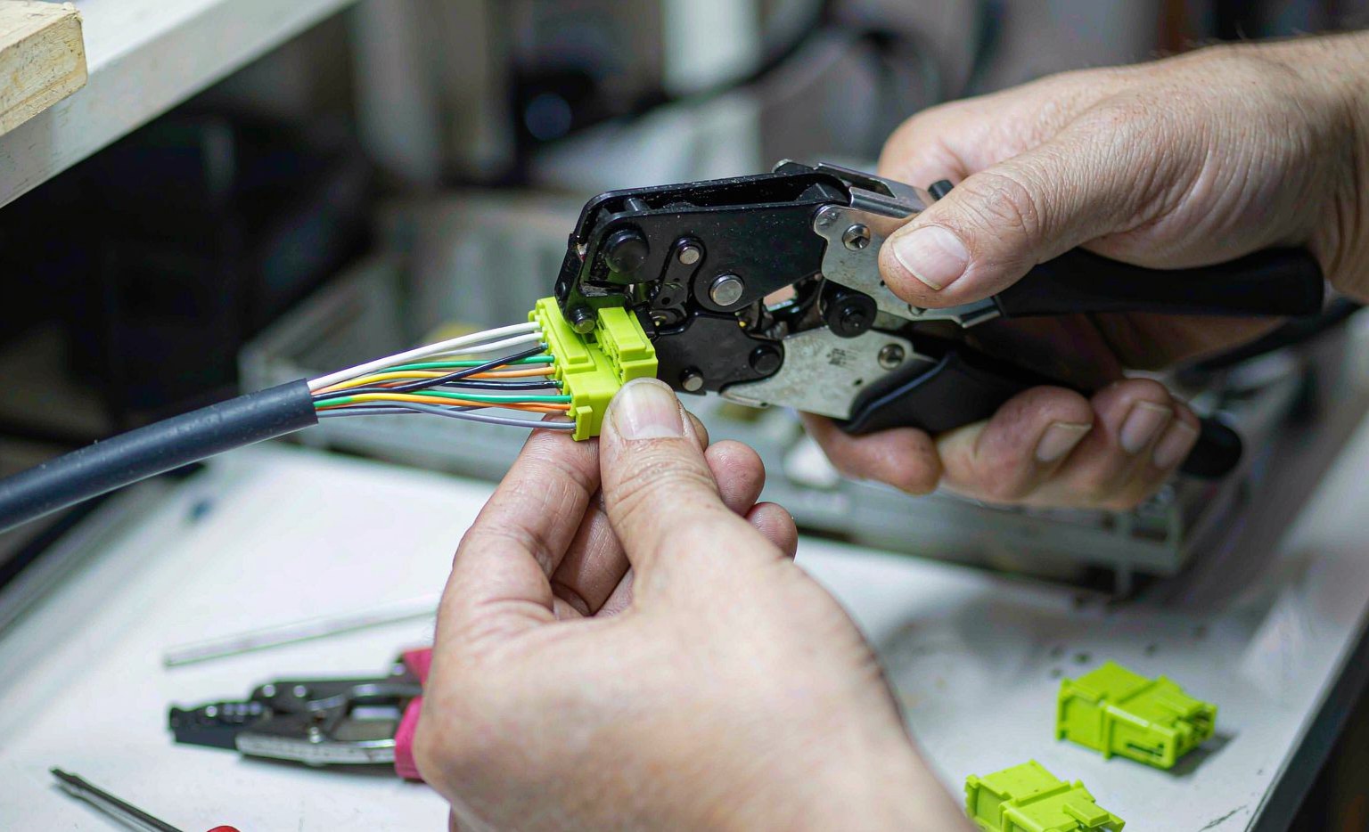 Technician crimping a connector onto a data cable
