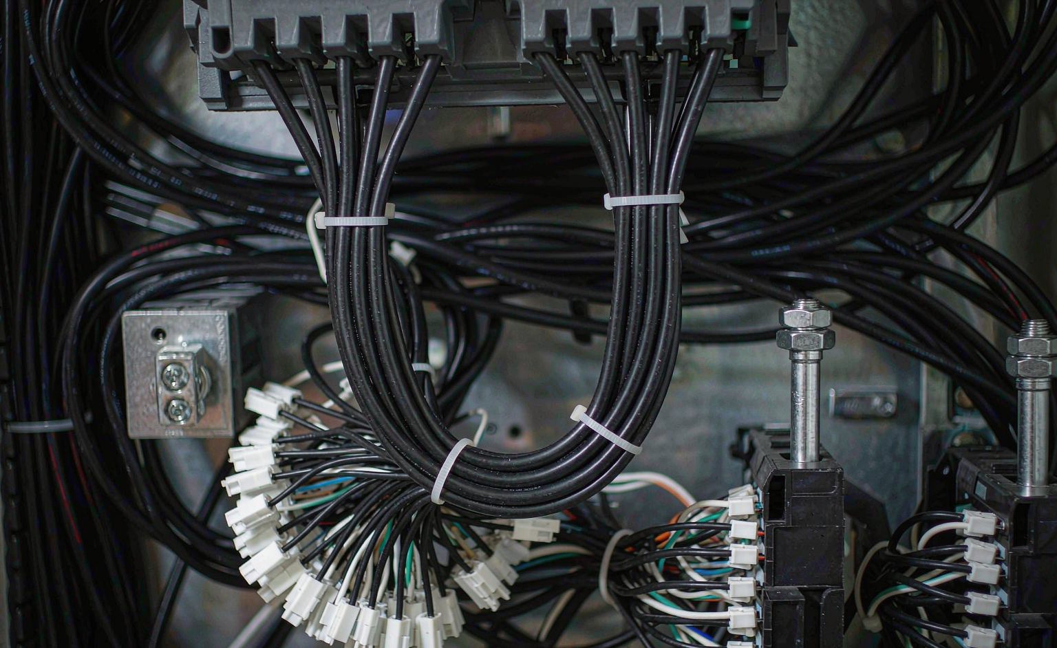 Industrial cable assembly routed with a service loop in a control panel