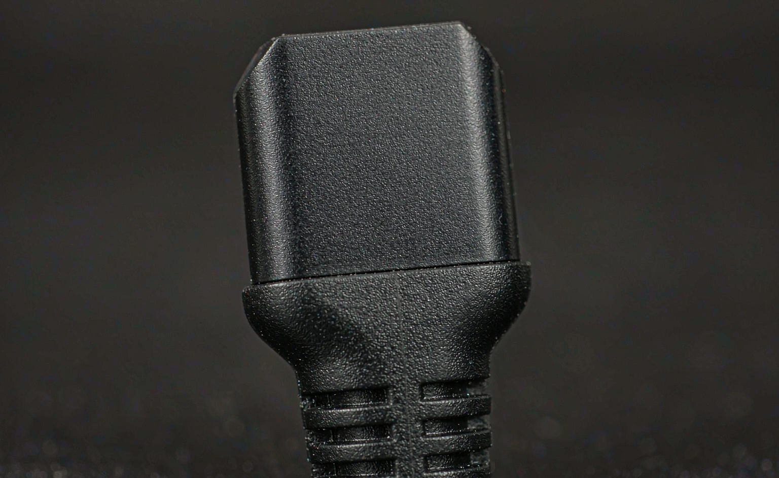Close-up of USB-C cable connector with certification marking on the shell